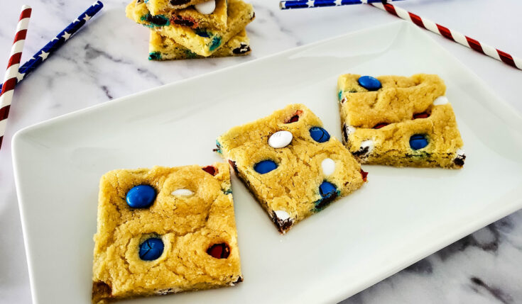 2 Ingredient Patriotic M&Ms Sugar Cookie Bars cuts into square on white plate