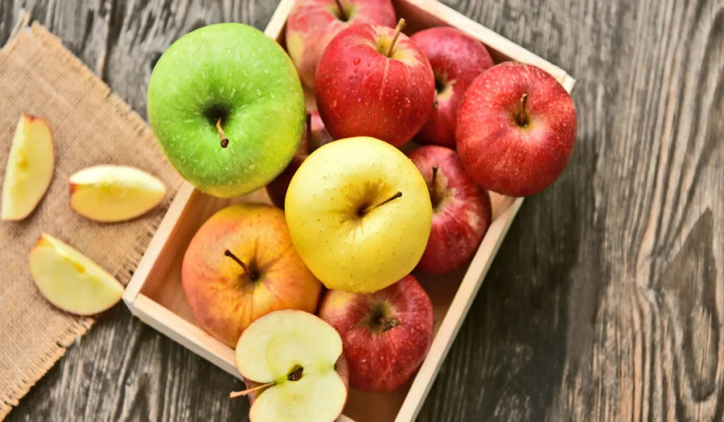 different types of apple in wooden crate