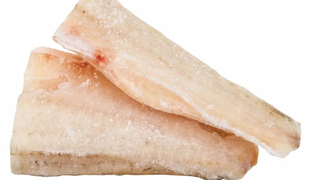 two pieces of frozen zander (pike-perch) fish fillet isolated on white background
