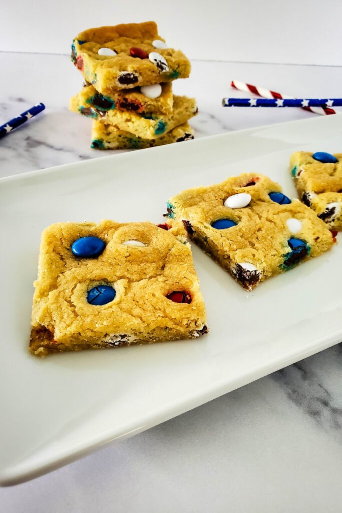 baked cookies with m&m's on a white plate