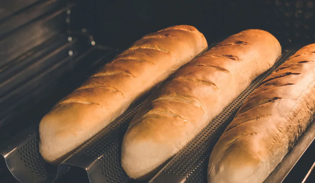 Freshly baked homemade baguette bread in a special baguette bread pan