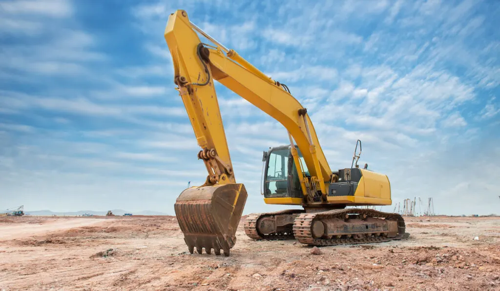 Heavy earth mover with blue sky in the background
