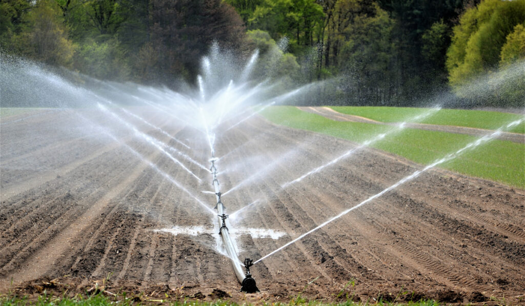 irrigation system watering crops on a farm land agriculture

