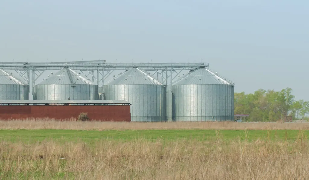 silos for agricultural goods in a warehouse on a farm field