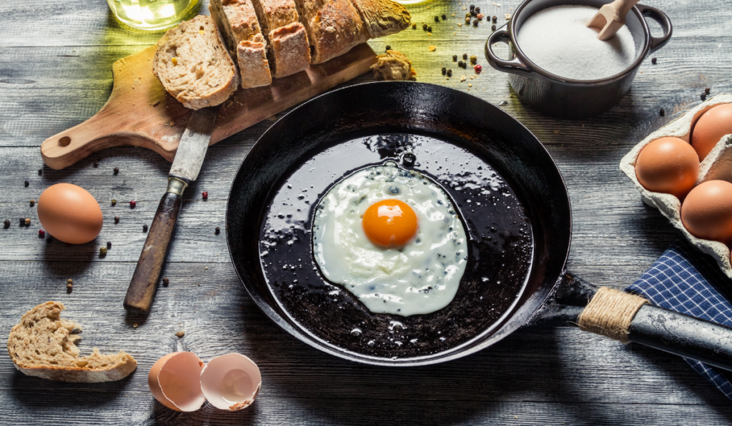 Fried egg on a pan and served with bread
