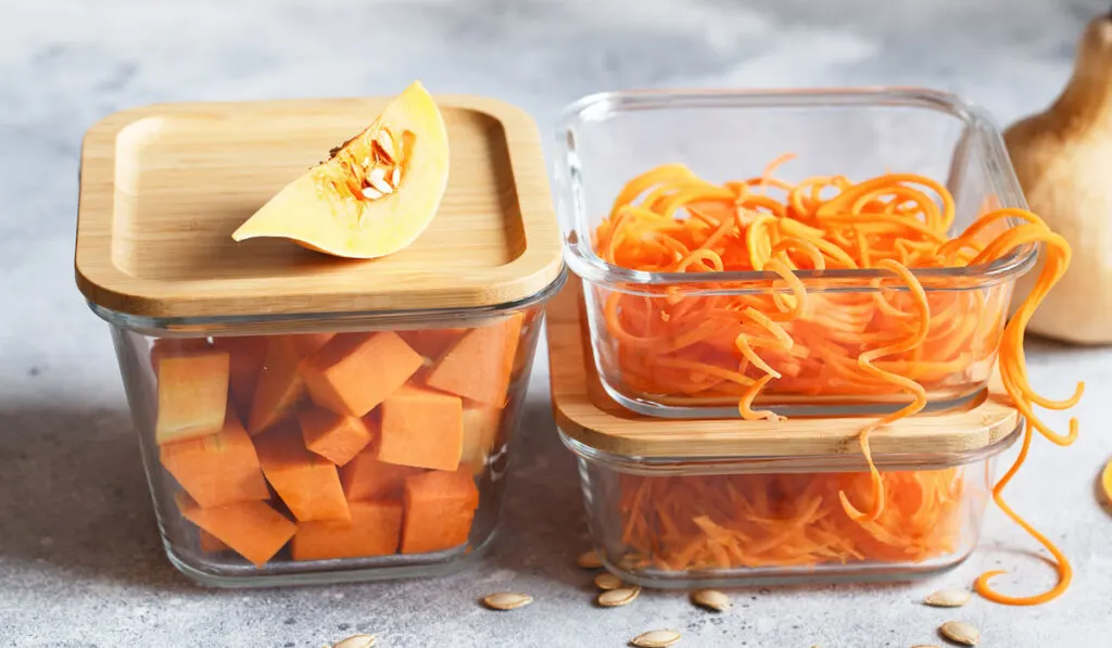 Shredded squash or pumpkin and cut squash in glass container