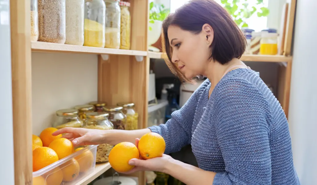 woman holding oranges