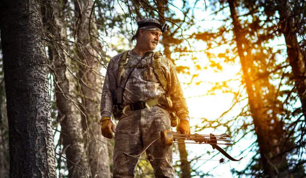 Hunter Looking down while standing in the forest