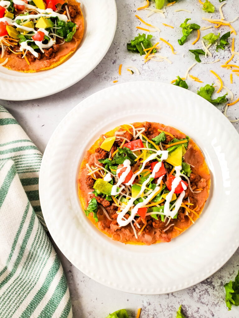 Bean and Beef Tostadas on white table with cloth 