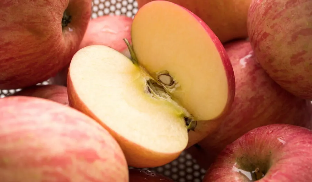 Close up of fresh, sliced red apples in the basket.