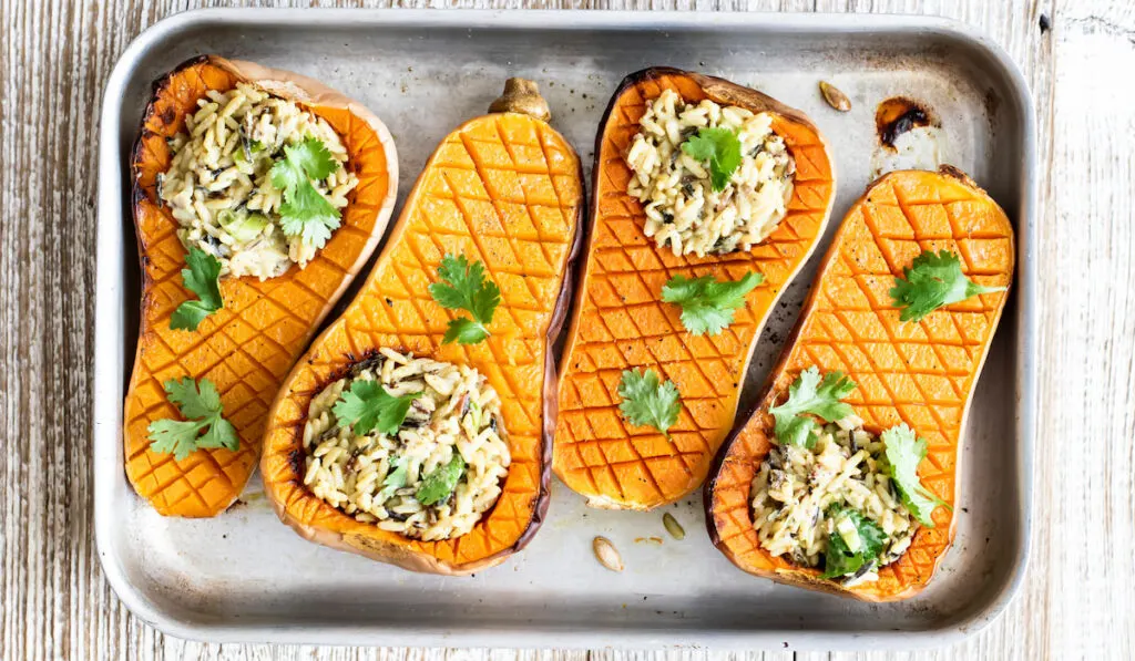 Delicious roasted butternut squash curry rice bowl on a tray