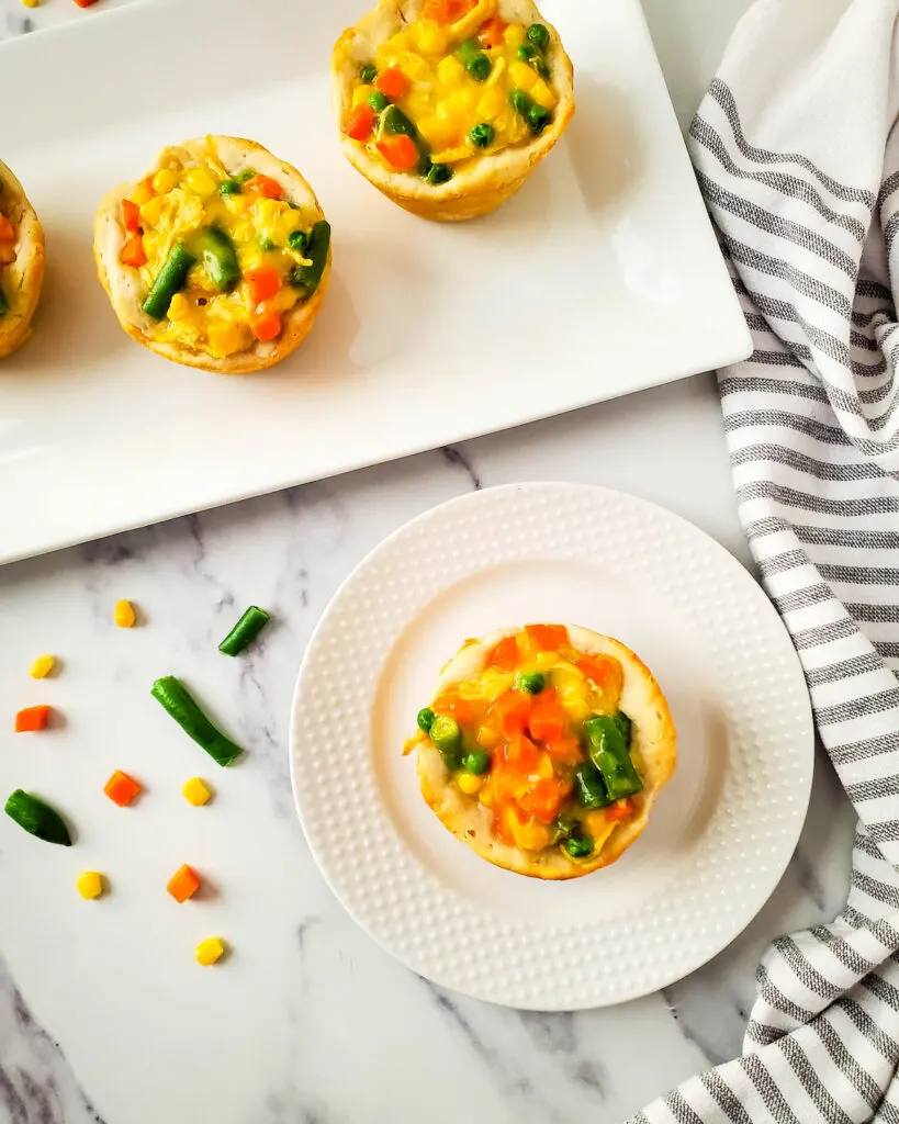 Easy biscuit pot pies on white plate on marble table
