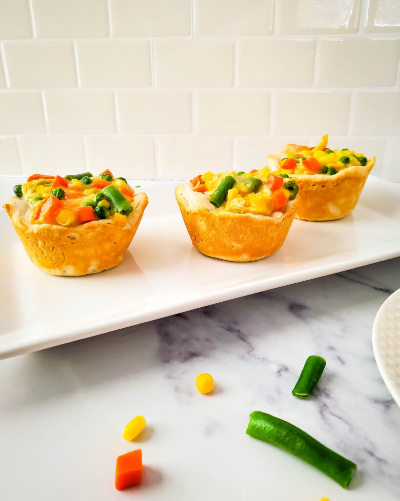 Easy biscuit pot pies on white rectangular plate on the table