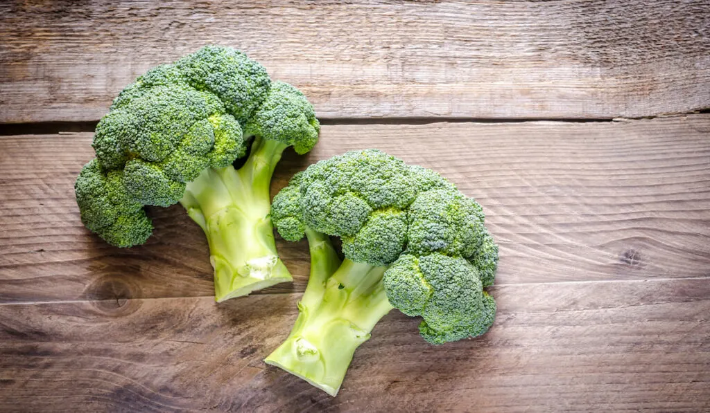 fresh broccoli on wooden table