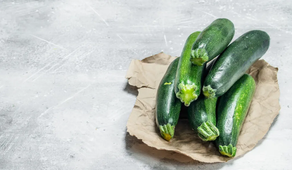 Fresh zucchini on brown paper from the market