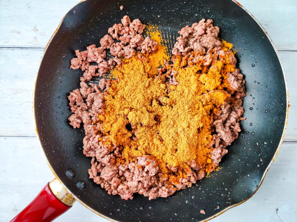 browned ground beef in a large skillet with taco seasoning