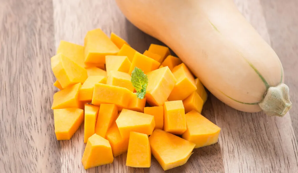 butternut squash slices on wooden table