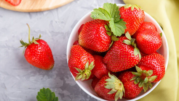 fresh and juicy red strawberries in a white bowl on the table