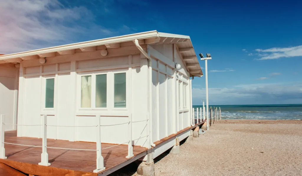 Small white bungalow house by the sea