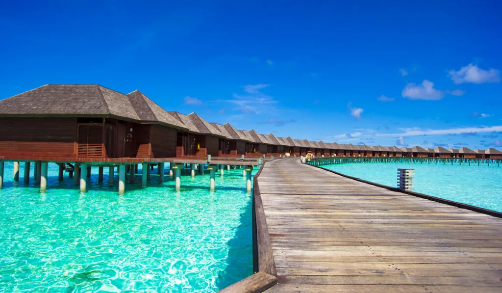 Water bungalows and wooden jetty on tropical island in Indian Ocean