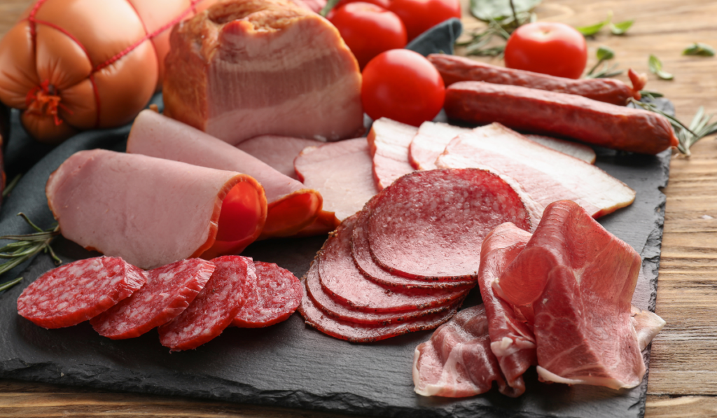 Assortment of delicious deli meats on slate plate
