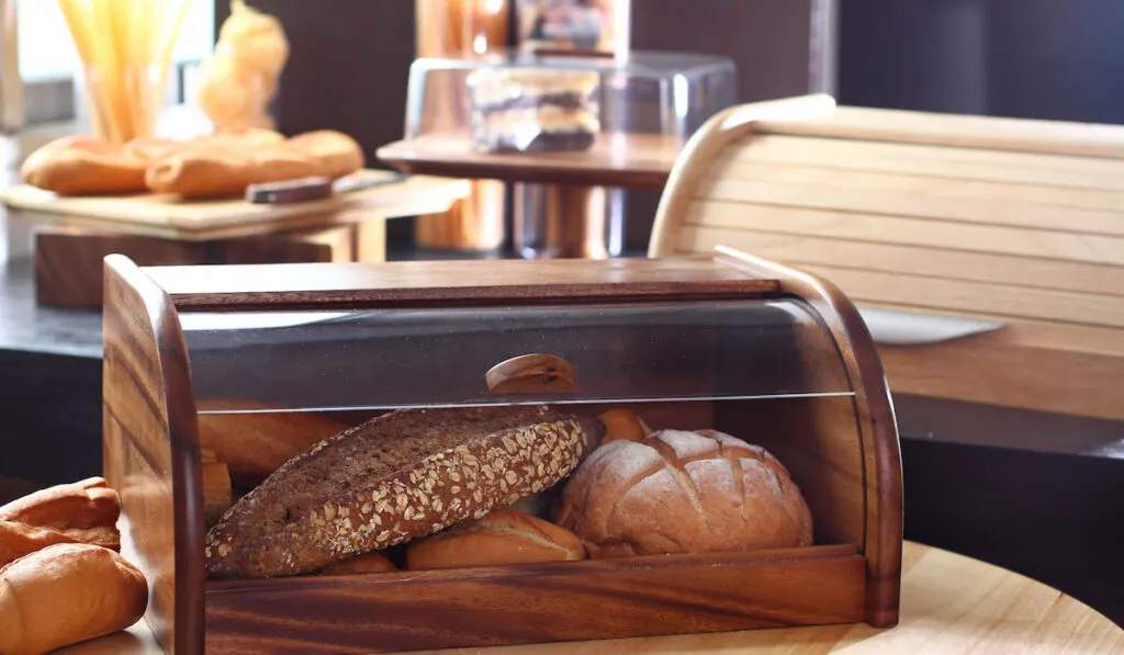 breads in wooden breadbox storage in the kitchen