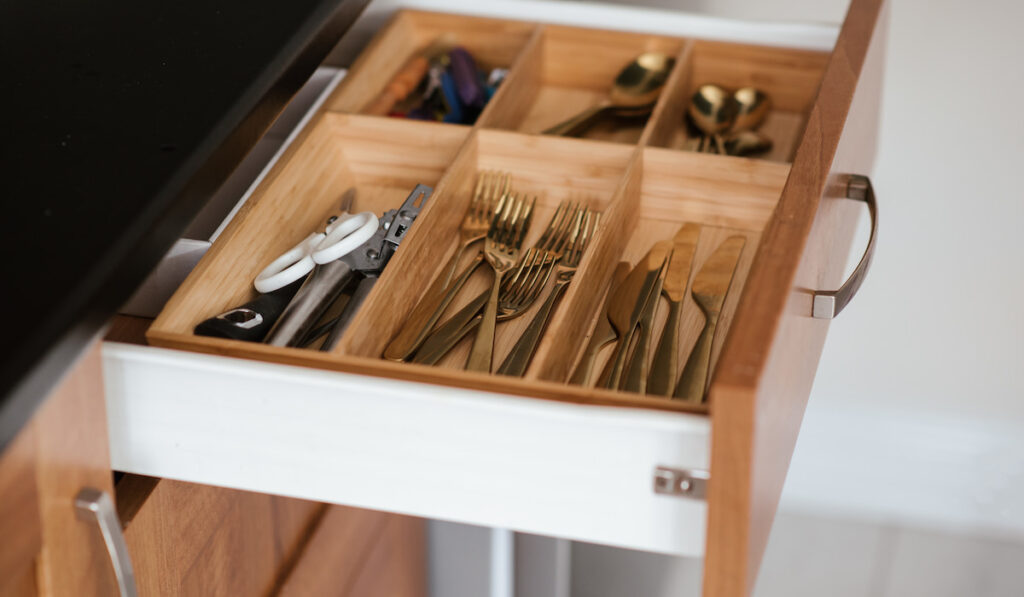 Different types of silverware in a  kitchen drawer