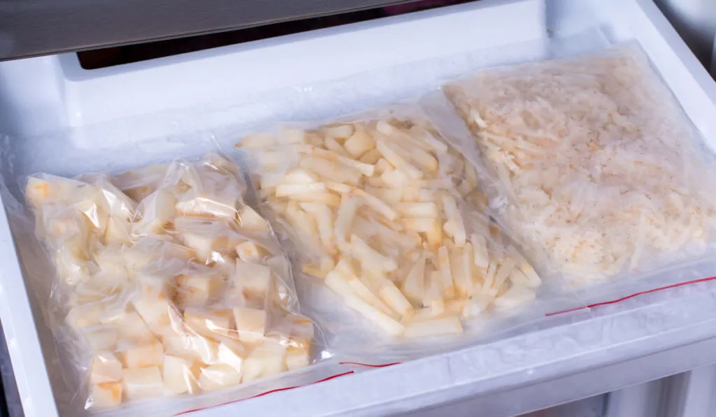 Frozen potatoes in bags in the freezer in the kitchen