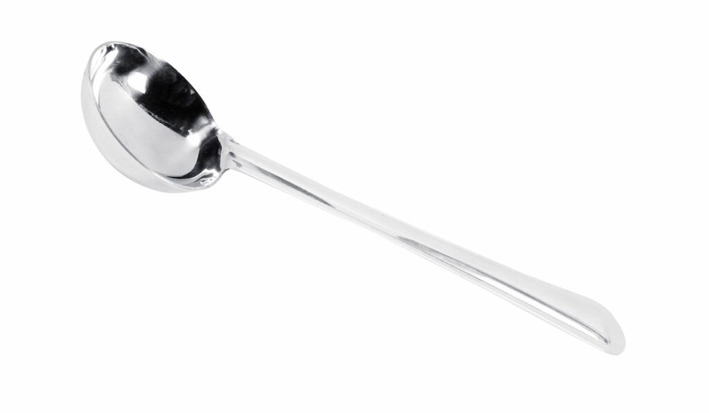 Metal soup ladle isolated over a white background

