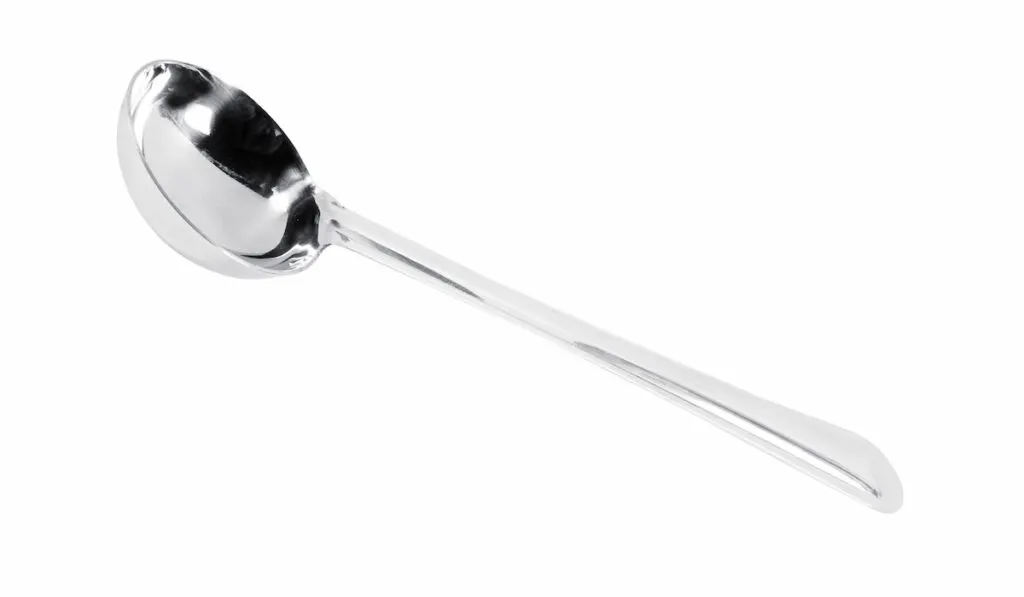 Metal soup ladle isolated over a white background

