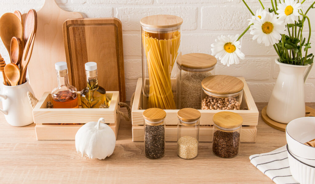 a set of different jars, containers for wounding spices and bulk products in a modern kitchen