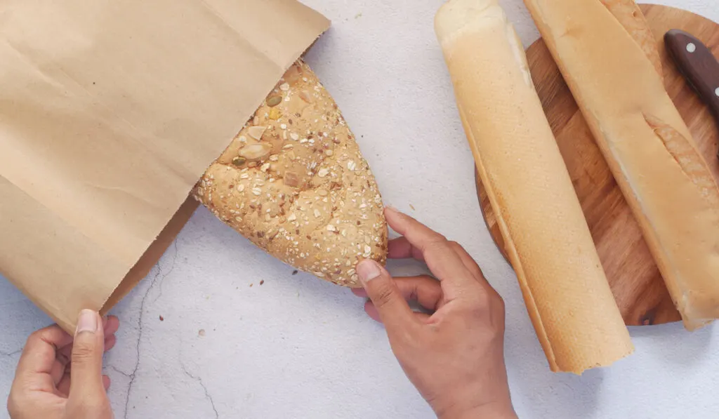 baked bread and paper bag on table