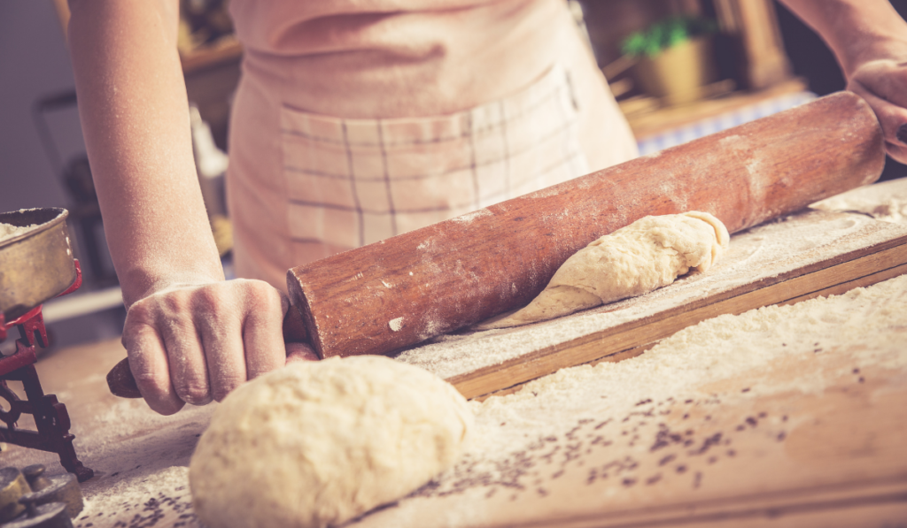 female baker hands kneading dough