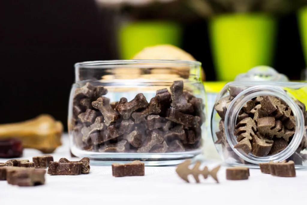 pet treats in an empty candle jars 