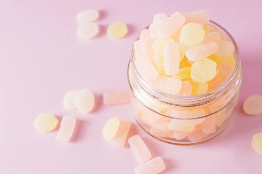 sugary gummies in an empty candle jar 