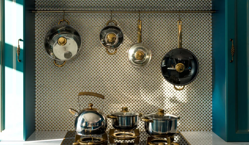 various dishware on stove and hanging in kitchen

