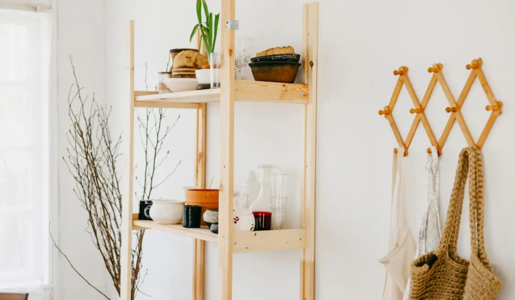 wooden shelves in the kitchen with dishes and decor in a rustic house