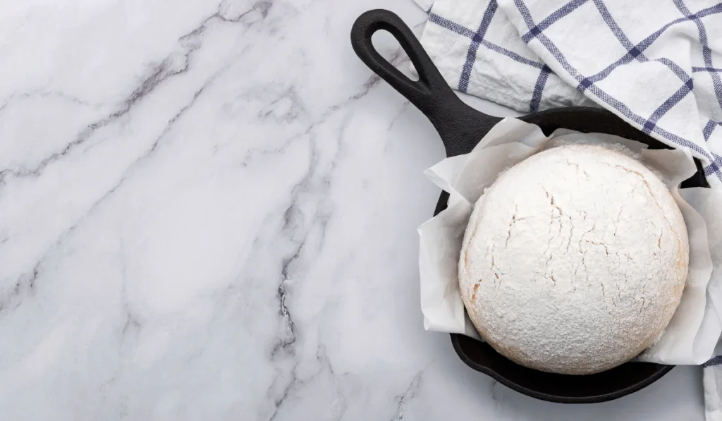 yeast dough resting in cast iron skillet 