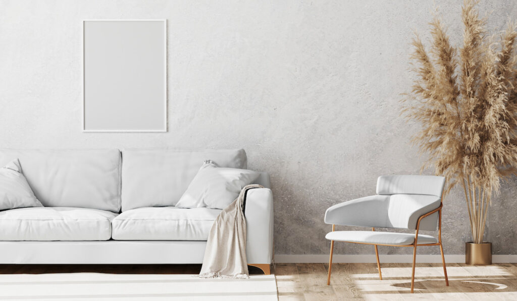 Blank white frame mock up in Light coloured minimalistic living room interior
