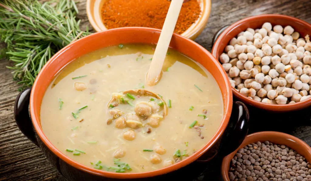 Traditional Harira soup with chickpeas lentils and herbs on the table