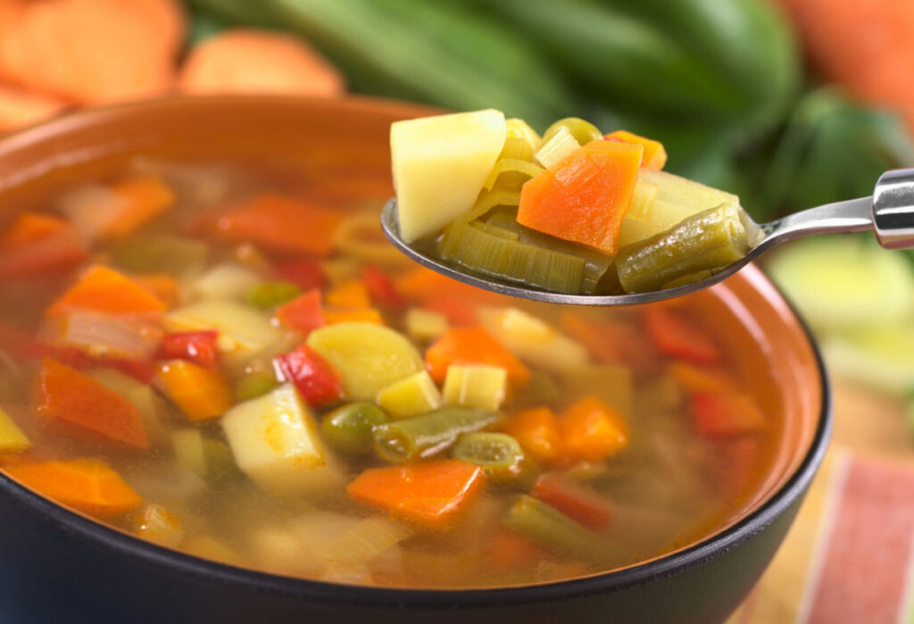 Vegetable Soup in a pot and in a  spoon 