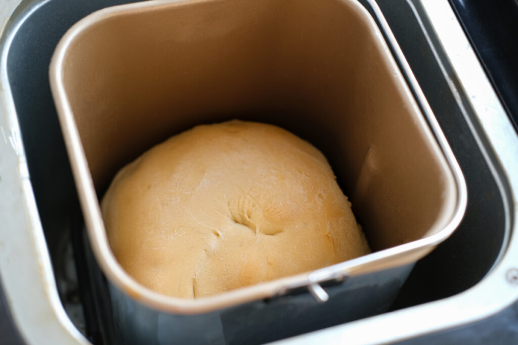 whole wheat bread baked in a bread making machine - e